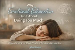 A woman resting her head on a table, reflecting emotional exhaustion that comes from suppressed emotions rather than doing too much.